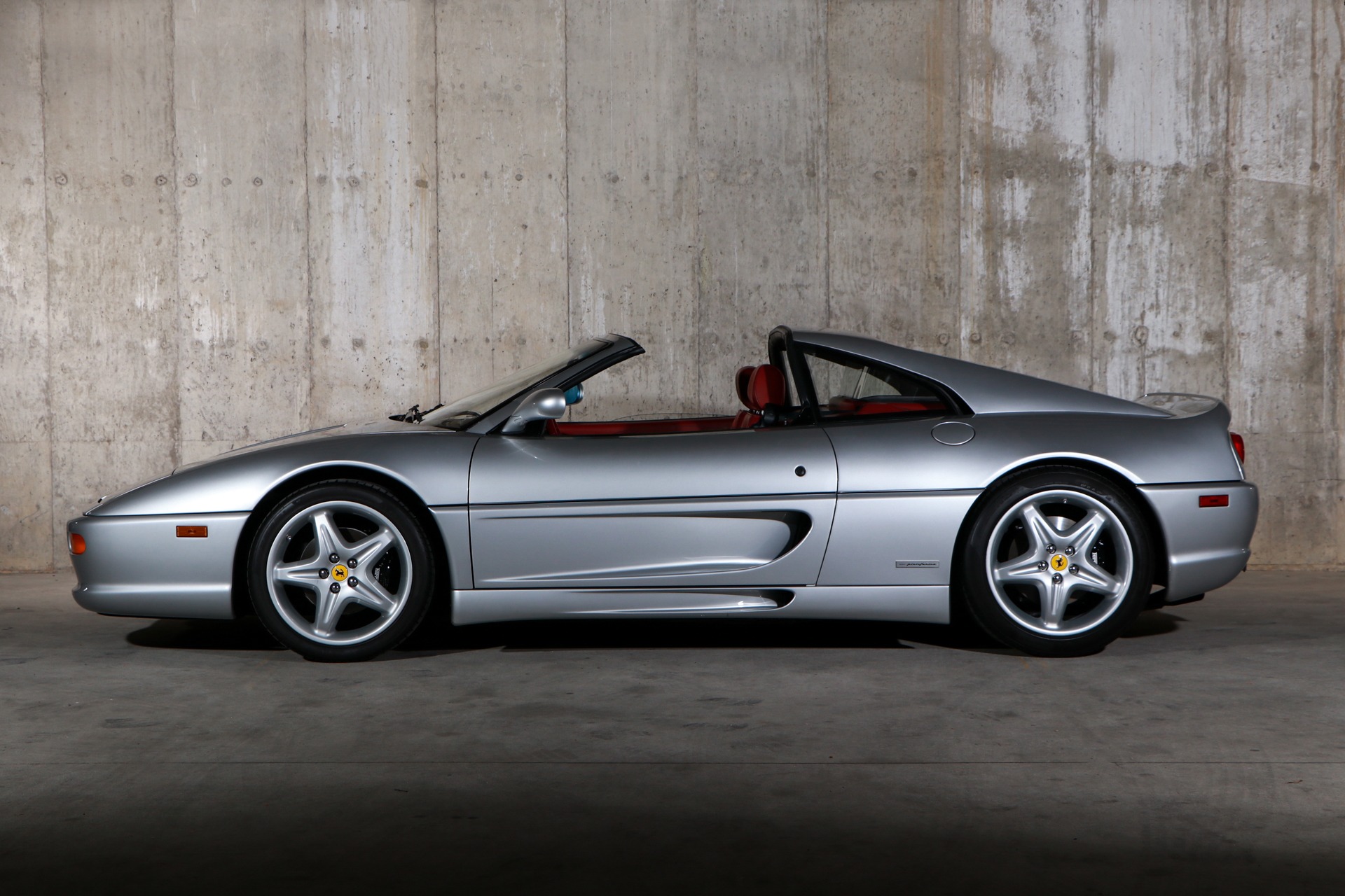 Silver Ferrari F355 GTS with targa roof removed, side profile